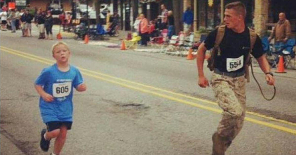 Marine sees 9-year-old struggling in marathon, slows down and holds his hand to help him finish
